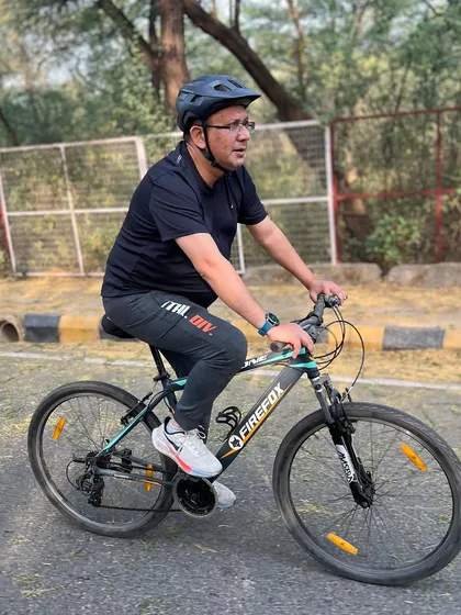 A member cycling on a quiet road. This shot captures the peaceful, meditative aspect of cycling.