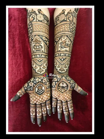 The full view of a classic bridal mehendi with intricate patterns. The palms feature symbolic motifs instead of portraits, perfect for brides who prefer a non-figurative design.