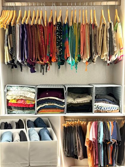 This wardrobe section showcases a mix of organized items, with hanging scarves, folded clothes in bins, and a dedicated section for men's t-shirts.