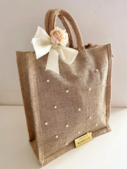 This pearl-studded jute bag is a beautiful and eco-friendly option for wedding favors or bridesmaid gifts.