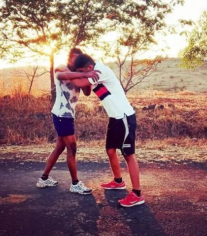 Two wrestling buddies training together as the sun sets. The dedication to Kusti extends beyond the akhada, with partners pushing each other to get stronger every day.