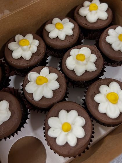 Sometimes simple is sweetest. These mini chocolate cupcakes are topped with a cute, hand-piped daisy, making them a lovely treat for any spring or summer gathering.