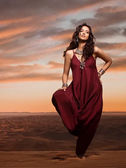 A dynamic pose from our bohemian desert series. The flowing outfit and the expansive landscape come together to create a feeling of freedom and adventure.
