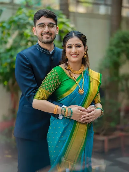 A warm and happy portrait of the couple. The soft blur in the foreground adds depth and focuses the viewer's eye on their connection.