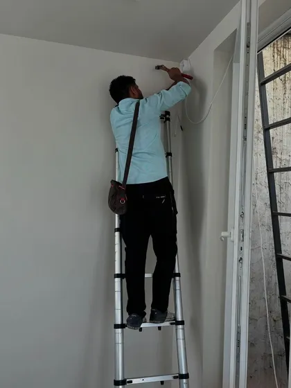 Another angle of the installation, showing the technician securing the camera and wiring. We make sure every component is firmly in place.