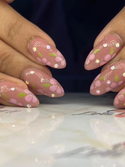 A close-up of the pretty floral and rhinestone nail art.