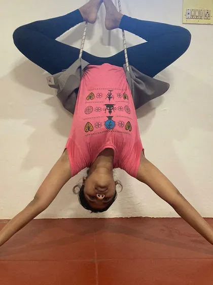 Using props like wall ropes is a key part of my teaching method for advanced poses. Here you can see my students in an inverted Baddha Konasana (Bound Angle Pose), using the ropes to decompress the spine and open the hips safely.