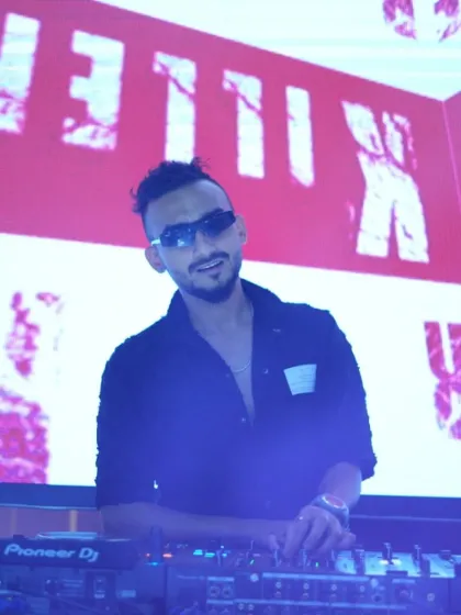 In my element behind the decks, with my name lit up behind me. This is the confidence and energy I bring to every performance.