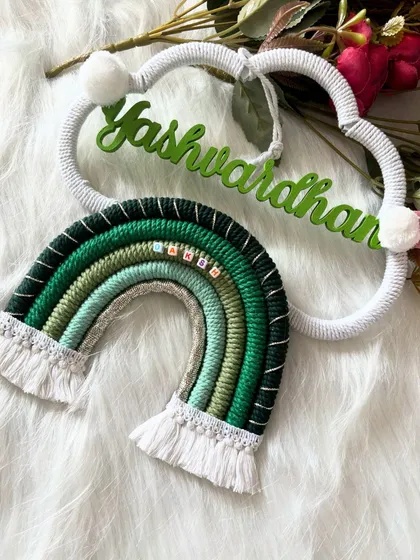 An angled shot of the 'Yashwardhan' piece, highlighting the texture of the macrame and the custom green name.