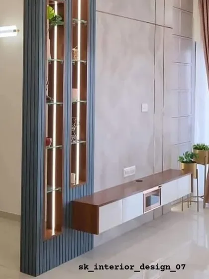 A floating TV console paired with a tall, illuminated display cabinet. This design acts as a partition while providing both storage and a beautiful display feature.