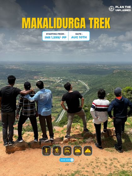 A group of friends looks out at the expansive view from the top of Makalidurga.