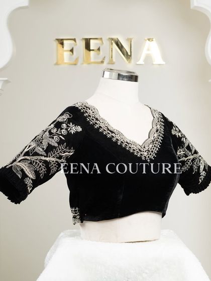 For a chic and contemporary look, I designed this black velvet blouse. It features intricate silver floral embroidery along the scalloped neckline and sleeves, creating a stunning contrast that is perfect for any special occasion.