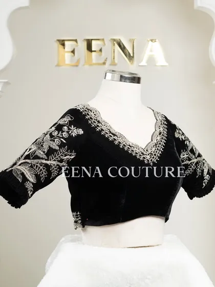 For a chic and contemporary look, I designed this black velvet blouse. It features intricate silver floral embroidery along the scalloped neckline and sleeves, creating a stunning contrast that is perfect for any special occasion.