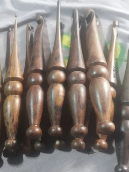 A collection of my dark wood crochet hooks in various sizes. These sturdy, handcrafted tools are perfect for working with all types of yarn, from fine threads to chunky weights.