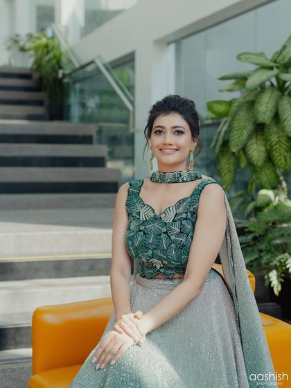 A smiling portrait that captures the client's happy and confident vibe in her stylish outfit.