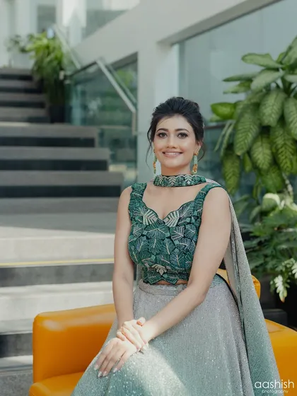 A smiling portrait that captures the client's happy and confident vibe in her stylish outfit.