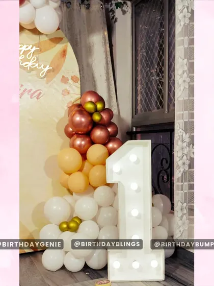 A close-up of the first birthday decor, highlighting the light-up number and the delicate balloon colors.