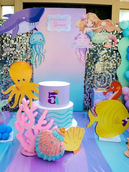 The full under-the-sea backdrop, featuring a variety of sea creatures, shimmering walls, and a beautiful cake stand.
