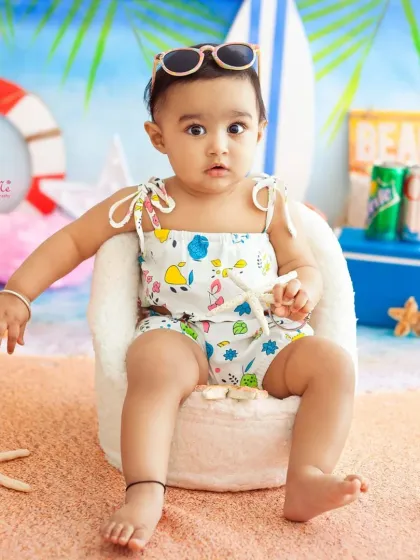 Looking so cool and relaxed in her little beach chair. The sunglasses are the perfect accessory for this sunny theme.