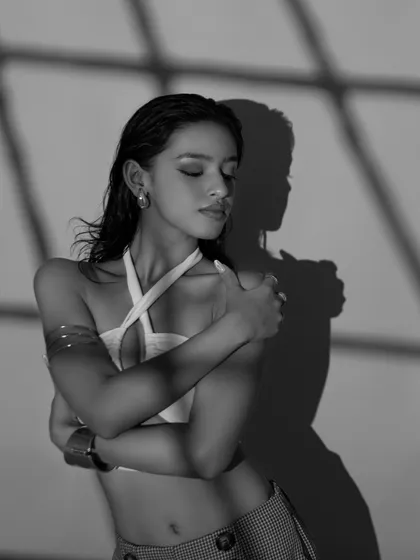 The black and white version of a serene, introspective pose. Removing the color allows the focus to be entirely on the emotion and the form.