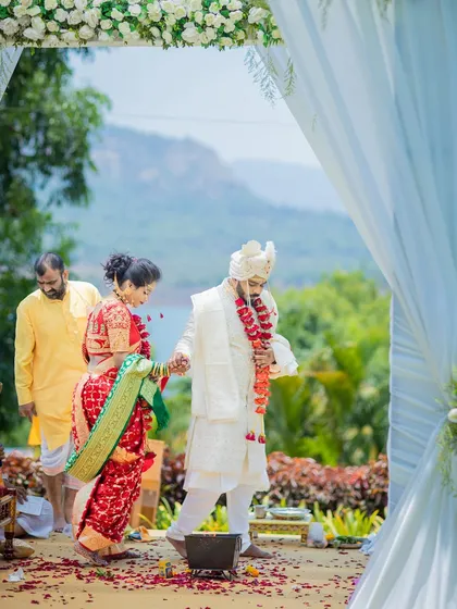 The bride and groom take their first steps together as a married couple during their outdoor ceremony.