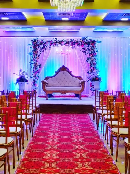 A full view of the Celebration banquet hall in Juinagar, set up for a wedding. The red carpet and floral stage create a festive look in this budget-friendly venue.