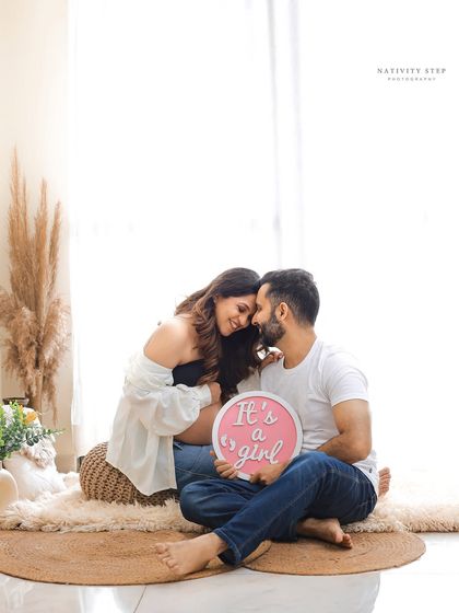 A beautiful and intimate gender reveal for a baby girl. The couple's loving embrace and the soft lighting create a very tender moment.