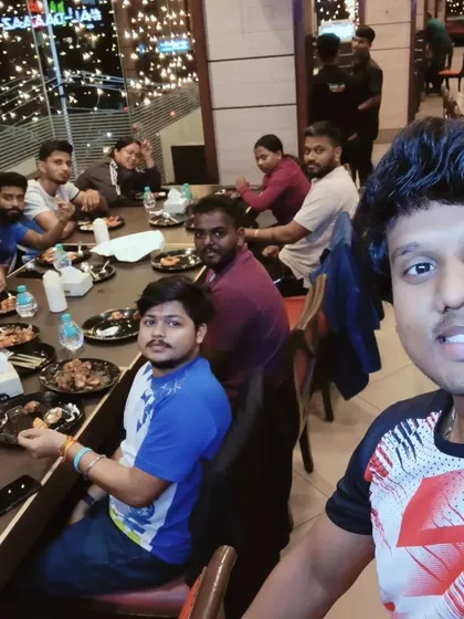 A selfie capturing a dinner outing with our coaching team. We believe in bonding outside the gym to strengthen our teamwork and friendship.