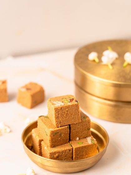 A close-up of my homemade Mohanthal, a rich and nutty sweet that is a highlight of my Sankranti hampers. Each piece is crafted to melt in your mouth.