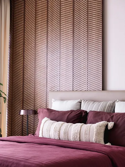 A close-up of the guest bedroom's headboard and bedding, showcasing the tactile quality of the materials we chose.