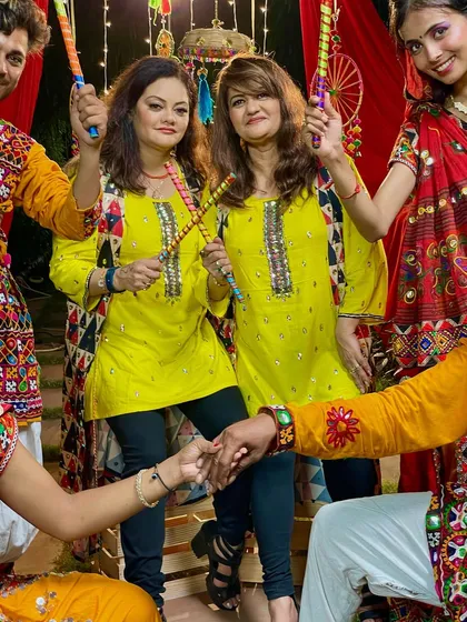 A close-up from our music video shoot, holding dandiya sticks and ready to dance. We love celebrating the rich traditions of Gujarati folk dance.