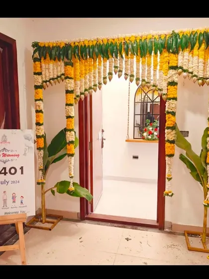 A traditional housewarming (Griha Pravesh) entrance decoration. I used classic marigold and jasmine garlands, banana leaves, and a personalized welcome sign to create an auspicious and beautiful entryway for the family's new home.