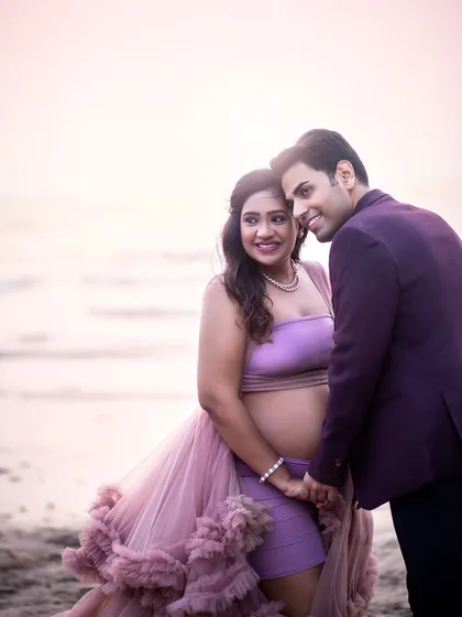 A tender moment from a beach maternity session. The soft pastel colors of the sky and the gentle embrace create a feeling of pure romance and peace.