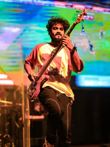 Our bassist grooving on stage, laying down the rhythm that gets the whole crowd moving.