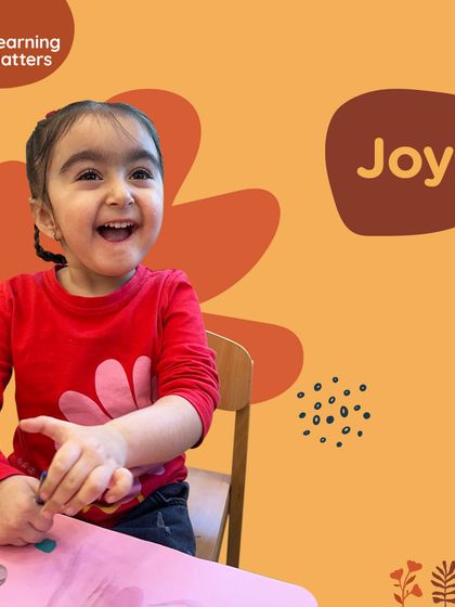 The pure joy on a child's face as she engages in a creative activity. We believe that joyful learning is transformative, fostering deeper engagement, resilience, and a love for knowledge that lasts a lifetime.