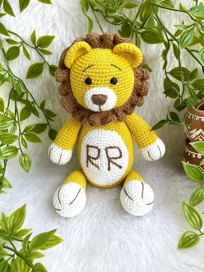 A royal lion plushie, personalized with the initials "RR" on his belly. This majestic friend is ready to rule the playroom with kindness.