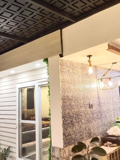 Another view of the Najafgarh site, showing the combination of a laser-cut pergola roof, mosaic tile wall, and modern lighting.