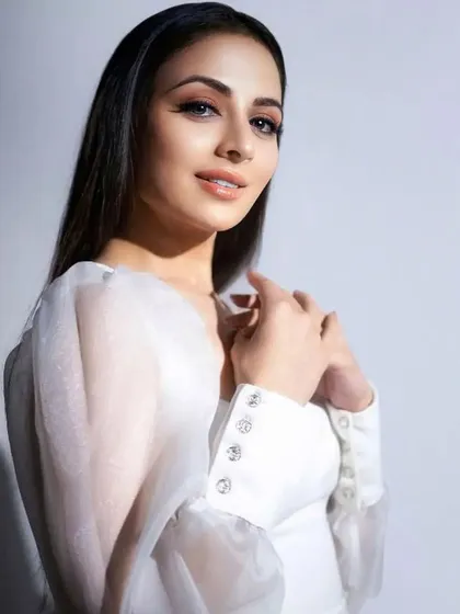 A close-up portrait where the sleek hair frames her face, drawing attention to her delicate features and soft makeup.