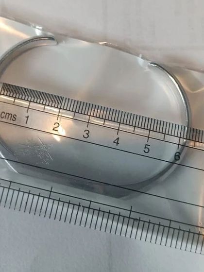 To give you a clear idea of the size, this image shows one of the silver kadas being measured. The open cuff design allows for a comfortable and adjustable fit.