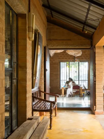 The veranda of the paper-making studio. This simple, transitional space provides a place for rest and informal meetings, connecting the indoor workshop with the green outdoors.