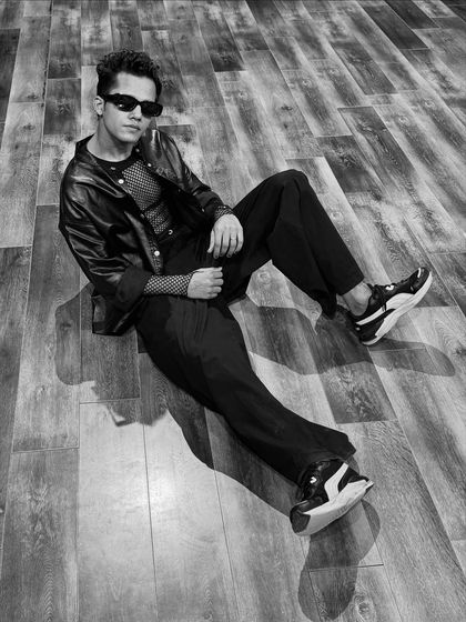 A high-angle, black and white shot from the studio floor, creating a dramatic and stylish look.
