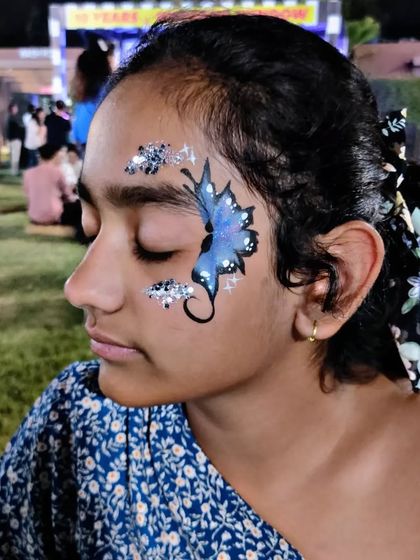 A beautiful blue butterfly design with a trail of sparkling silver glitter.