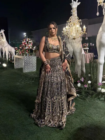 Posing against the beautiful decor, this lehenga truly shines. It's a perfect example of royal wedding attire for a host.