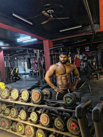 Dream big, pose bigger. A classic pose in front of the dumbbell rack. This is where dreams are built.