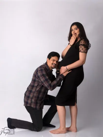 A fun and candid moment! Her surprised expression as he listens to the bump is priceless and shows their playful connection.