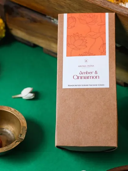 A festive scene featuring our Amber & Cinnamon incense cones. Each non-toxic, clean-burning cone burns for about 20 minutes, but its warm and spicy scent lingers for much longer.