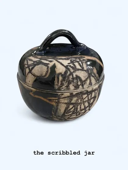'The Scribbled Jar', a hand-built lidded pot with an abstract, expressive surface decoration. This piece is perfect for storing small treasures or as a standalone piece of ceramic art.