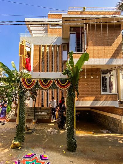 The Divyadarshan residence during its housewarming ceremony. This home, built on a compact 110 sq ft site, showcases how we use verticality and clever openings like these pivoted windows to create a sense of space and connection to the outside.