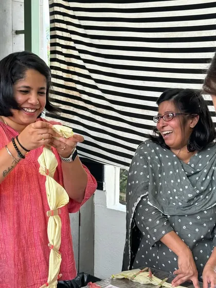 Laughter and learning go hand-in-hand at my workshops. Here, participants share a joyful moment while learning different tie-dye folding techniques.
