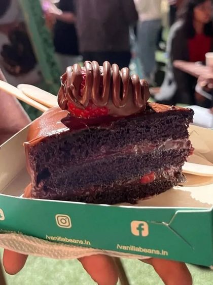 A slice of our signature Nutella Strawberry cake in its takeaway box, ready to be devoured at The Lil Flea.